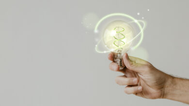 green energy with hand holding environmental light bulb background